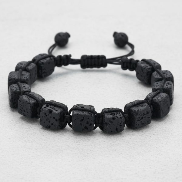Gros plan d'un bracelet homme en cubes de pierre de lave tissé macramé sur cordon ajustable