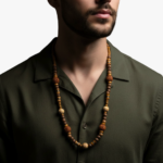 Collier perles de bois homme long perles mixtes sculptées symbole om porté sur chemise sombre fond gris anthracite