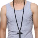 Homme portant un collier chapelet pendentif crucifix en bois sculpté noir perles de bois, t-shirt gris sans manches