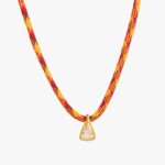Collier cordon tressé rouge orange jaune pendentif triangle zircon blanc monture dorée fond blanc
