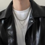 Collier homme double couche chaîne et pendentif étoile porté avec veste en cuir noir t-shirt blanc