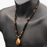 Collier oeil de tigre homme marron et obsidienne noire pendentif pierre brute naturelle sur buste noir
